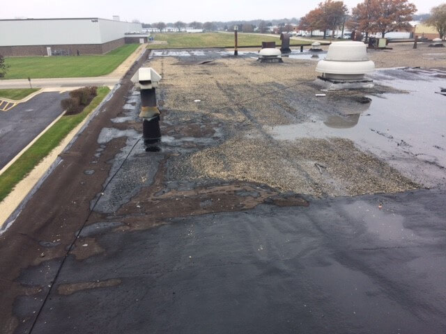 Flat roof with drain leak on commercial building in Atlanta GA
