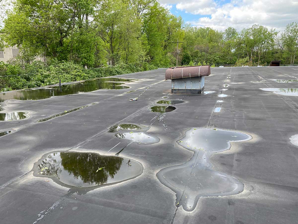 Flat roof with drain leak on commercial building - Commercial Roofing Atlanta GA